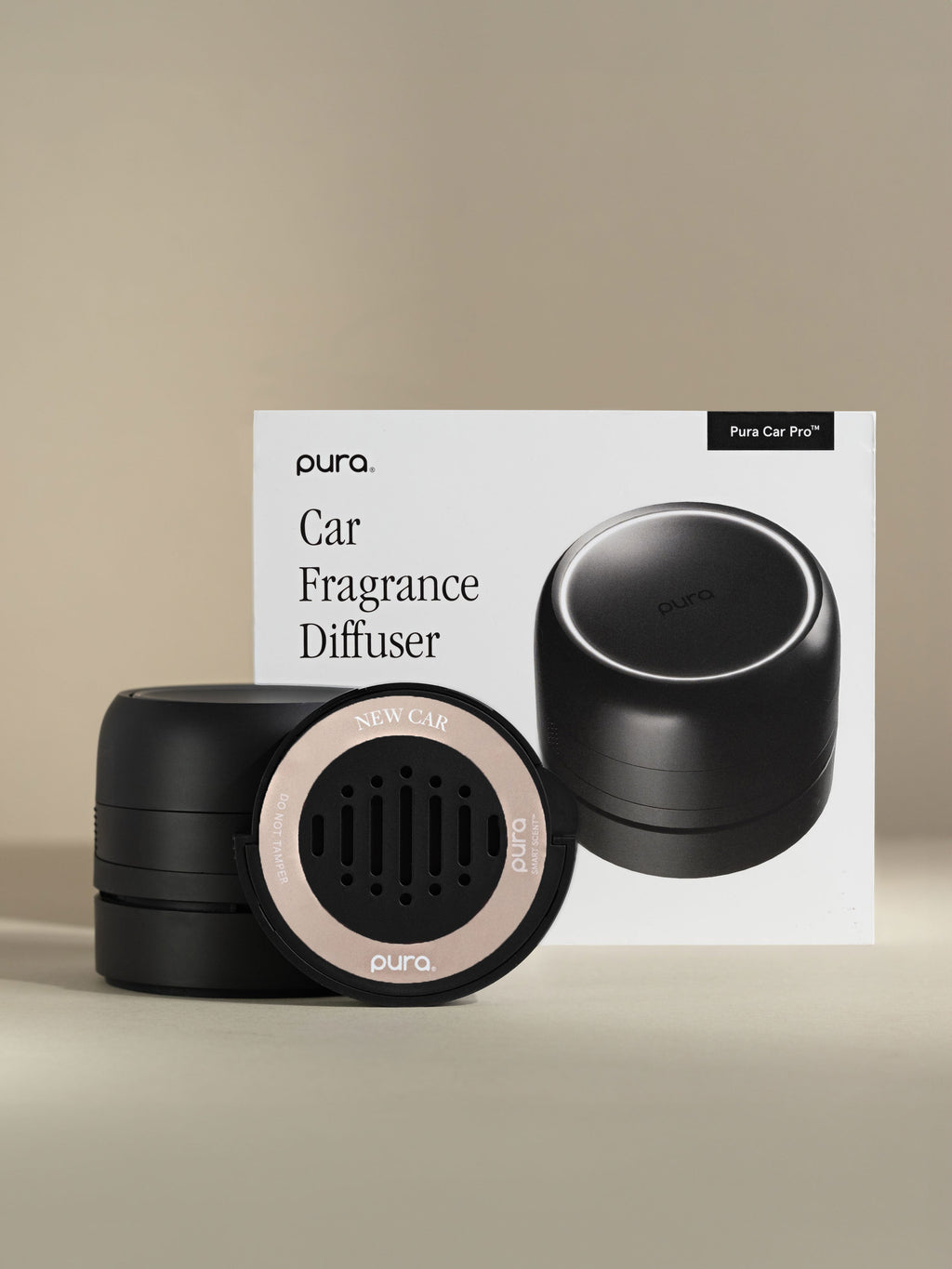 Pura Car Pro diffuser, New Car car fragrance, and packaging on a beige background